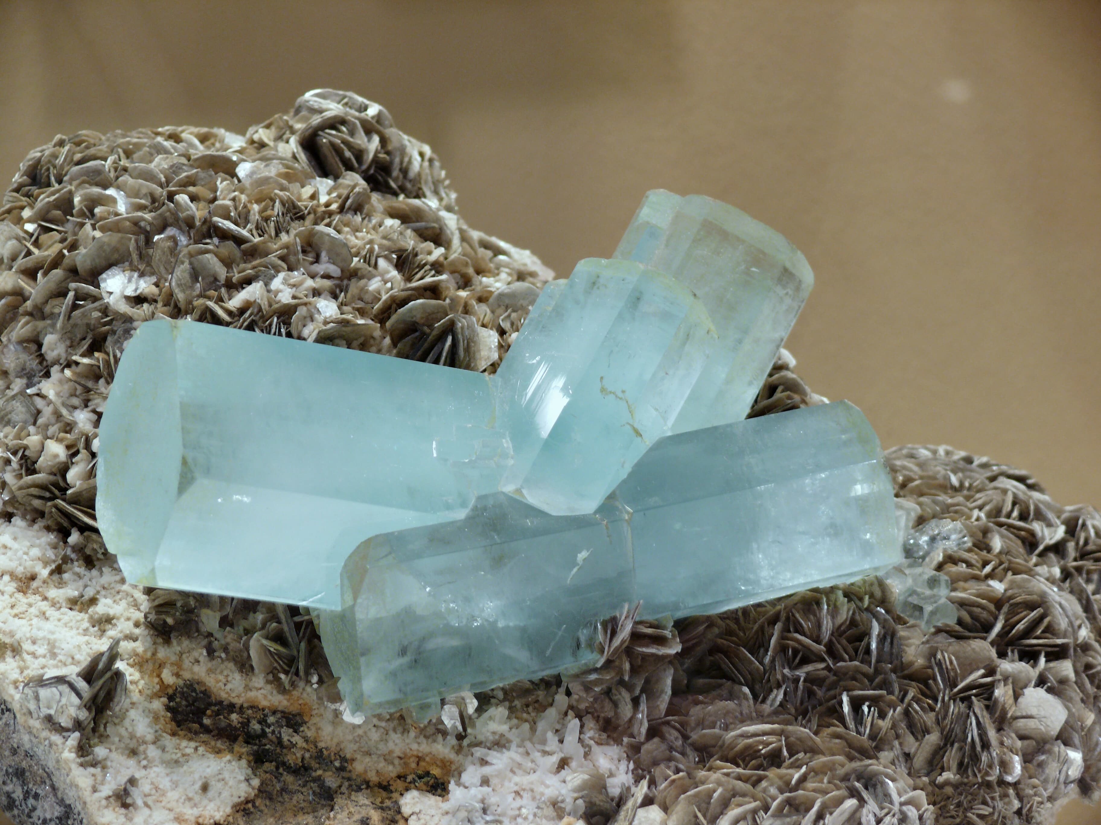 Faceted aquamarine crystal with sea-blue transparency and clean internal clarity, catching light in cool blue-green tones