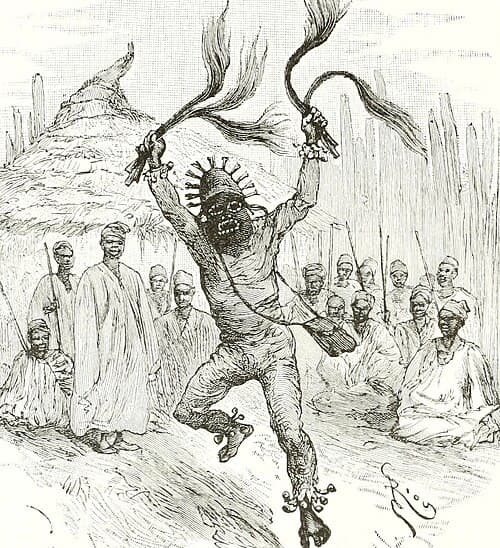 A precisely drawn veve of Erzulie Freda showing a heart and flowers in white cornmeal on a dark floor surrounded by candles