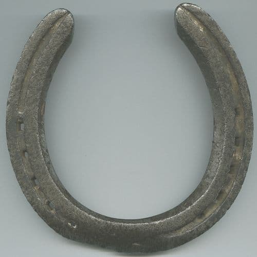 Iron horseshoe charm in traditional Russian style hung points-up for good luck